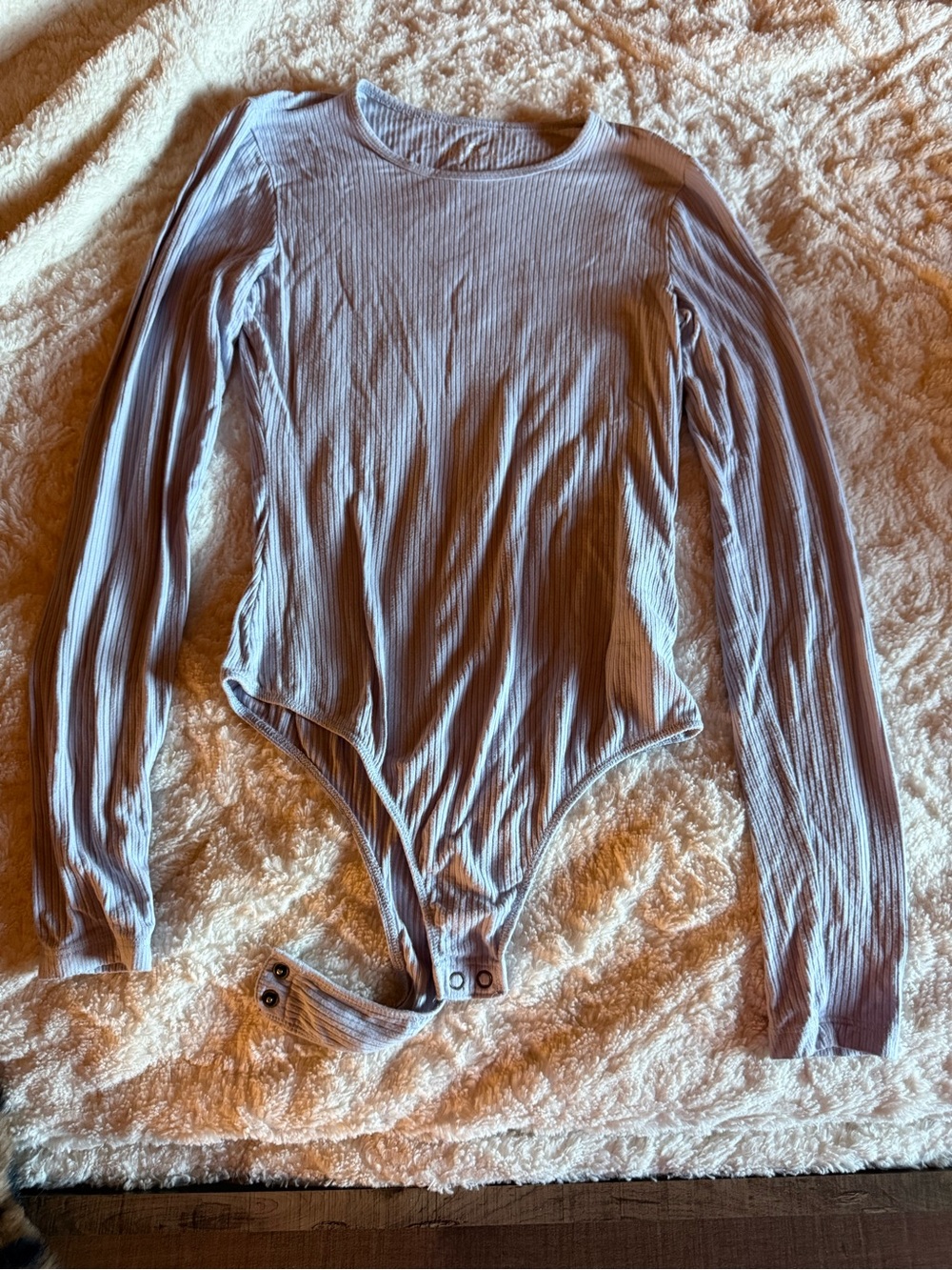 Women’s blue ribbed body suit.